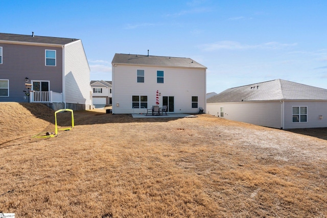 rear view of property featuring a yard and a patio