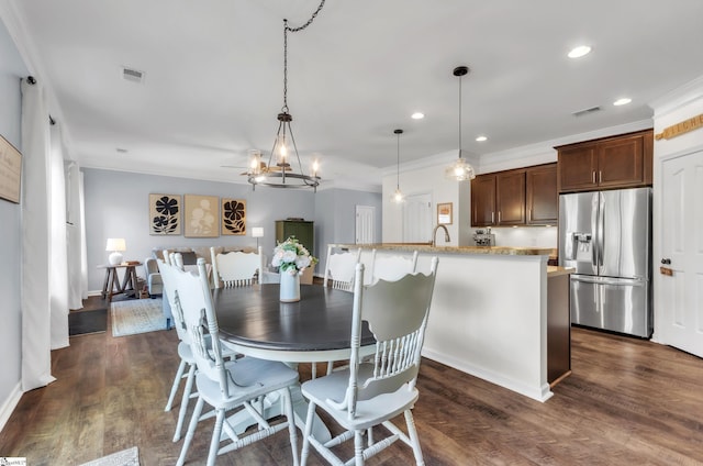 dining space with recessed lighting, visible vents, dark wood-type flooring, and ornamental molding