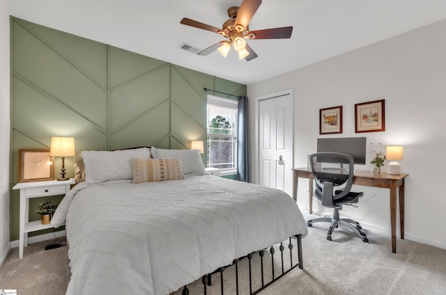 bedroom with carpet flooring, baseboards, visible vents, and a closet