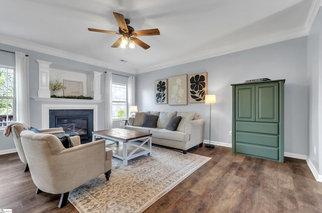 living room featuring a glass covered fireplace, baseboards, and dark wood-style flooring