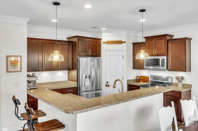 kitchen featuring decorative light fixtures, appliances with stainless steel finishes, light countertops, and ornamental molding