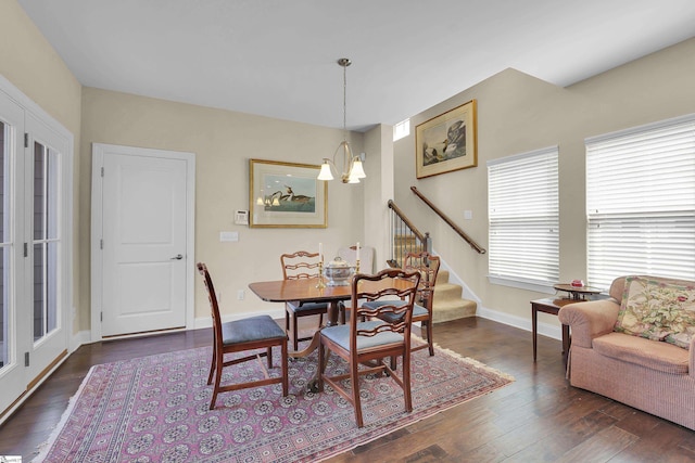 dining area with stairs, an inviting chandelier, baseboards, and dark wood-type flooring