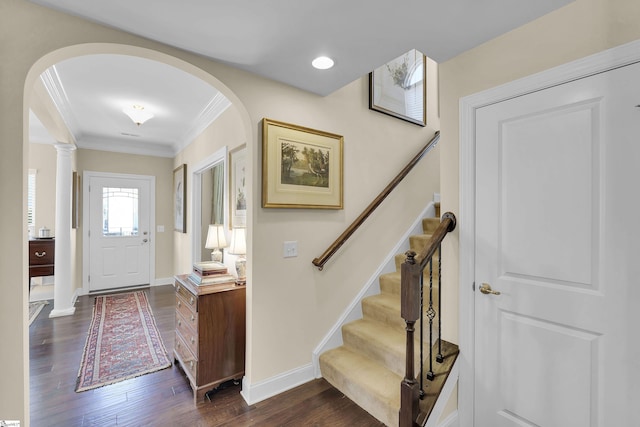 entryway with stairway, baseboards, dark wood-type flooring, and crown molding