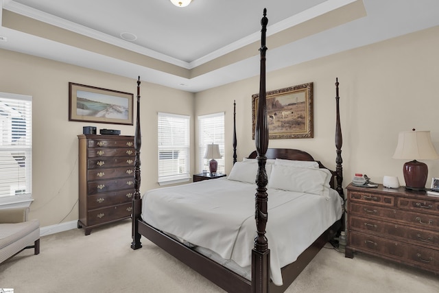 bedroom with multiple windows, a raised ceiling, light carpet, and ornamental molding