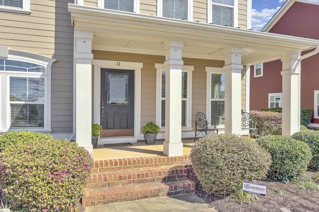 view of exterior entry featuring a porch