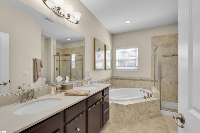 full bath with visible vents, a shower stall, a garden tub, and a sink