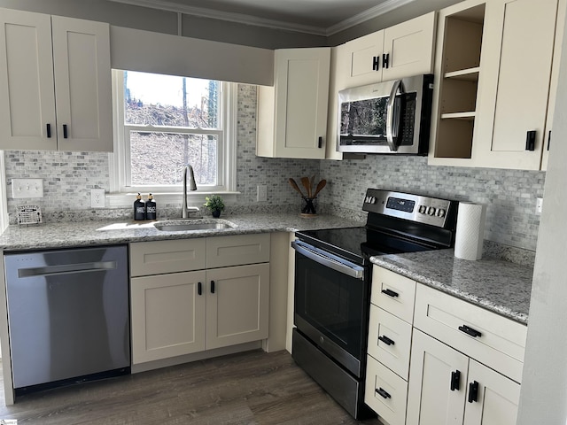 kitchen featuring a sink, stainless steel appliances, white cabinets, light stone countertops, and dark wood-style flooring