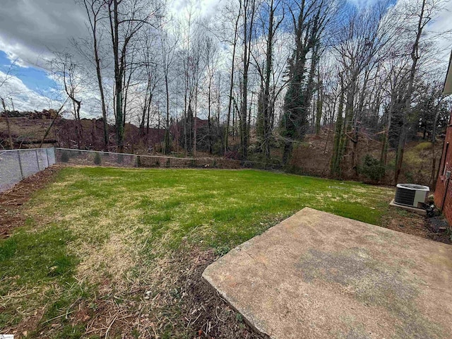 view of yard with a patio, central AC, and fence