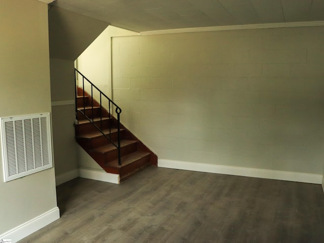 stairs featuring ornamental molding, wood finished floors, visible vents, and baseboards