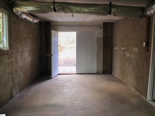 entrance foyer featuring concrete flooring and concrete block wall