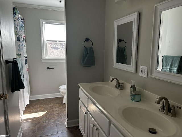 bathroom with a sink, baseboards, toilet, and double vanity