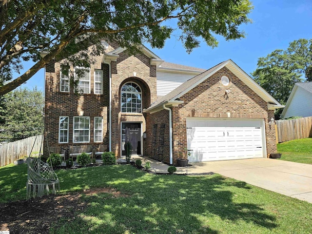 traditional home featuring brick siding, a front lawn, fence, a garage, and driveway