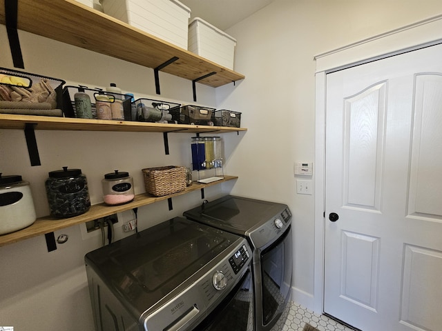 laundry room featuring laundry area, separate washer and dryer, and baseboards