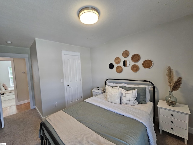 carpeted bedroom featuring baseboards