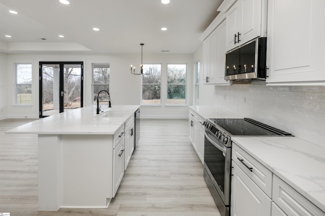 kitchen with a sink, a healthy amount of sunlight, recessed lighting, and stainless steel appliances