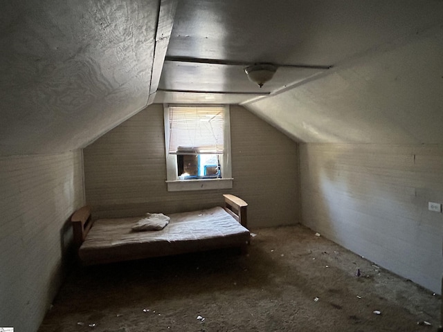 unfurnished bedroom featuring lofted ceiling