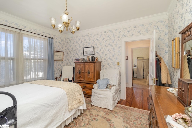 bedroom with wallpapered walls, crown molding, a notable chandelier, and wood finished floors