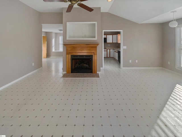 unfurnished living room featuring baseboards, lofted ceiling, ceiling fan, and a fireplace