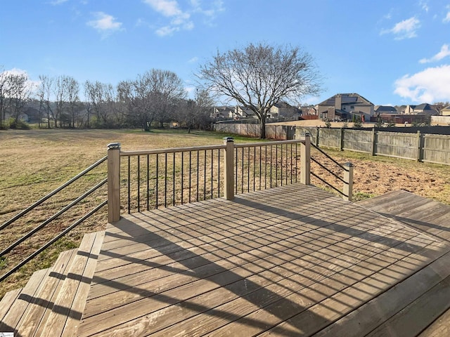 wooden deck featuring a yard and a fenced backyard