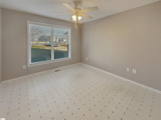 empty room featuring visible vents, baseboards, and ceiling fan