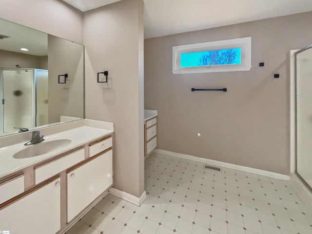 bathroom with tile patterned floors, visible vents, a shower stall, and vanity