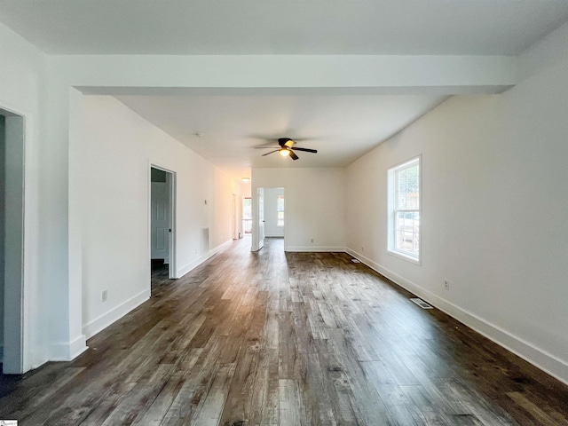 unfurnished living room featuring visible vents, baseboards, dark wood-type flooring, and a ceiling fan