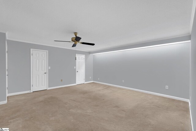 unfurnished room featuring ceiling fan, baseboards, light carpet, and ornamental molding