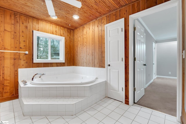 bathroom with tile patterned floors, wooden walls, wood ceiling, and a bath