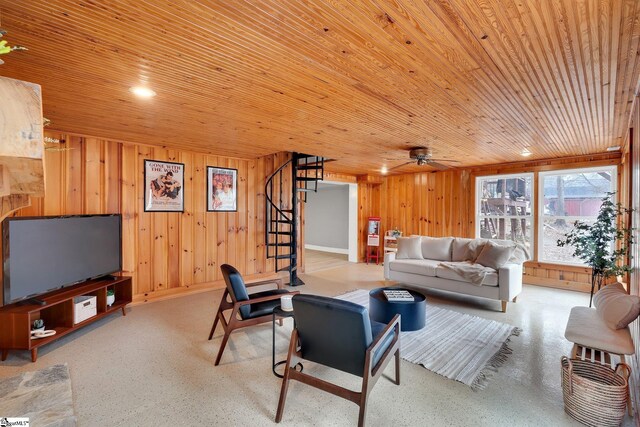 living room with wood walls, wood ceiling, and stairs