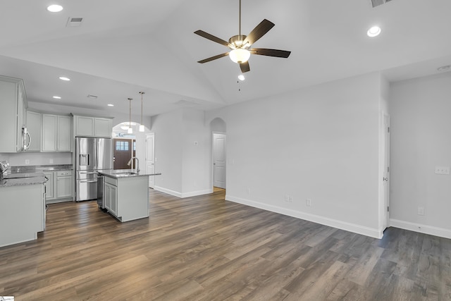 kitchen featuring dark wood-type flooring, visible vents, arched walkways, and appliances with stainless steel finishes