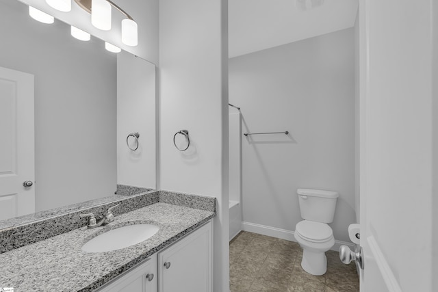 bathroom with vanity,  shower combination, toilet, and baseboards