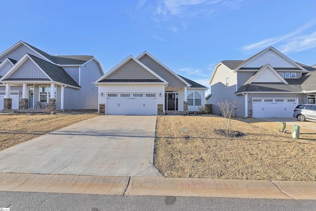 craftsman inspired home featuring stone siding, an attached garage, and driveway