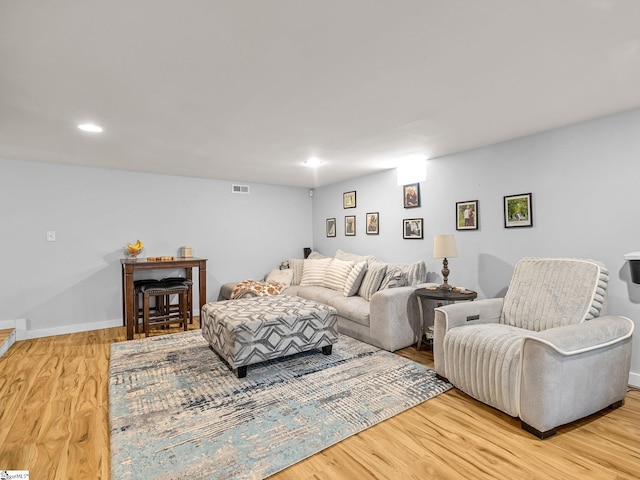 living room featuring recessed lighting, wood finished floors, visible vents, and baseboards