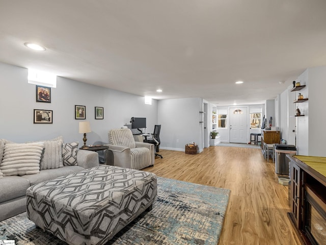 living room featuring light wood finished floors, recessed lighting, and baseboards