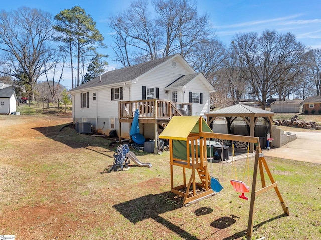 exterior space featuring a gazebo, a playground, cooling unit, and a lawn