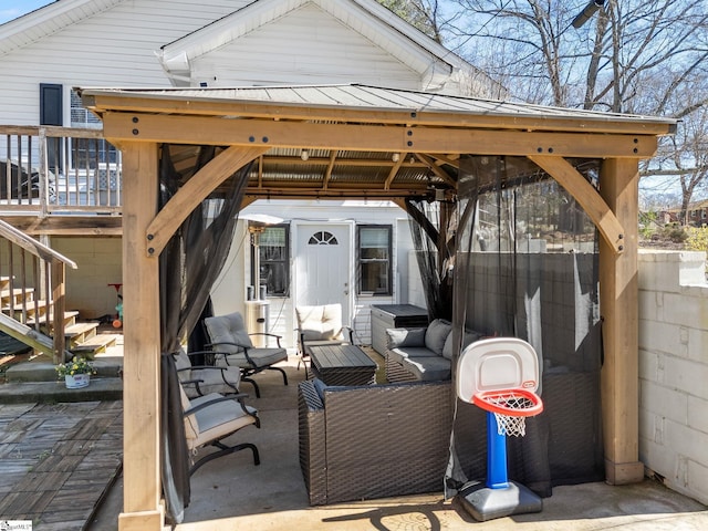 view of patio featuring a gazebo, an outdoor living space, and fence