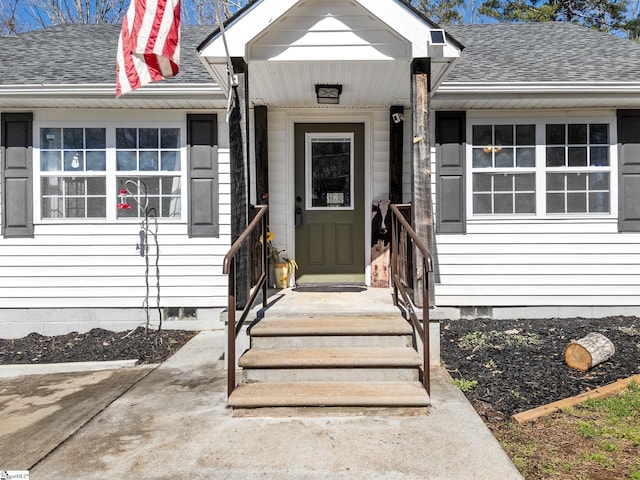 doorway to property featuring crawl space and roof with shingles