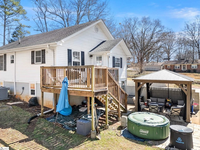 back of house featuring central air condition unit, a deck, a gazebo, a shingled roof, and an outdoor hangout area