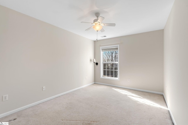 spare room featuring visible vents, baseboards, carpet, and a ceiling fan