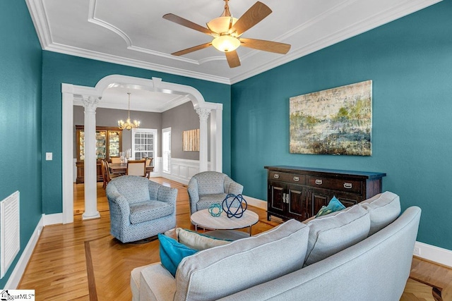 living room with visible vents, arched walkways, crown molding, and ornate columns