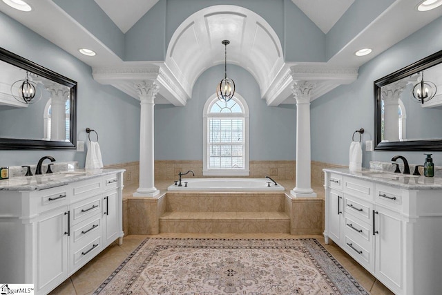 bathroom featuring a sink, decorative columns, lofted ceiling, and tile patterned floors