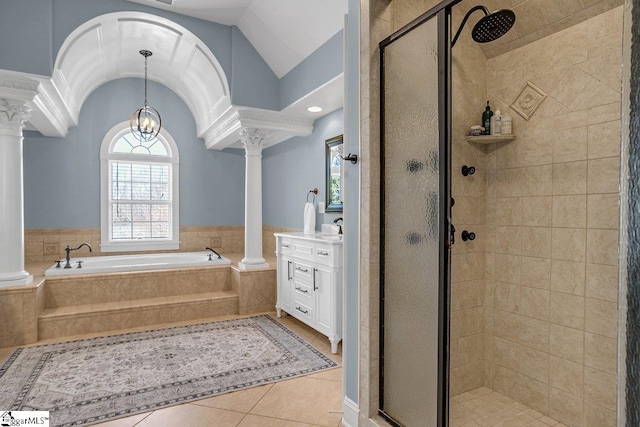 full bathroom with a shower stall, tile patterned flooring, decorative columns, lofted ceiling, and a bath