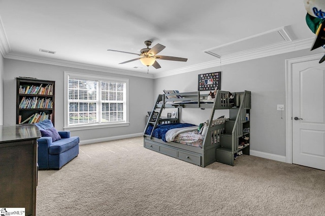 carpeted bedroom with visible vents, crown molding, ceiling fan, baseboards, and attic access