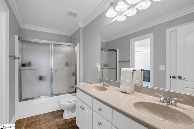 bathroom featuring visible vents, toilet, crown molding, and a sink