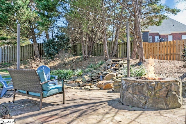 view of patio / terrace featuring a fire pit and fence