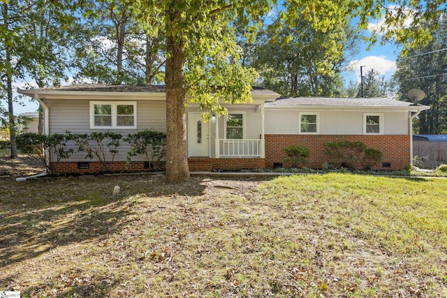 ranch-style home with a front yard, brick siding, and crawl space