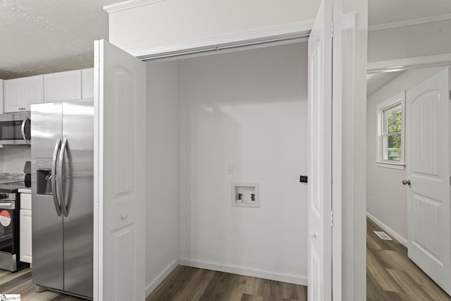 clothes washing area featuring visible vents, baseboards, washer hookup, and wood finished floors