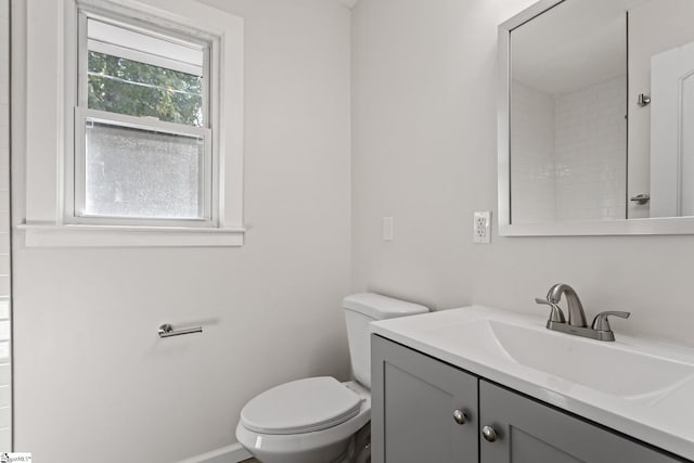 full bath with vanity, toilet, and baseboards