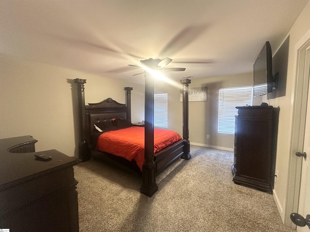 carpeted bedroom with baseboards and a ceiling fan