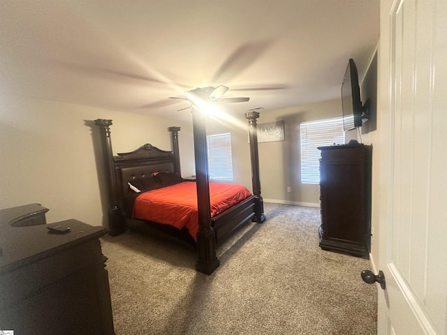 carpeted bedroom featuring baseboards and ceiling fan